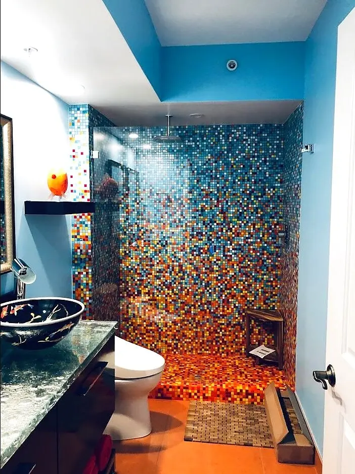 Vibrant mosaic-glass feature wall in a bathroom