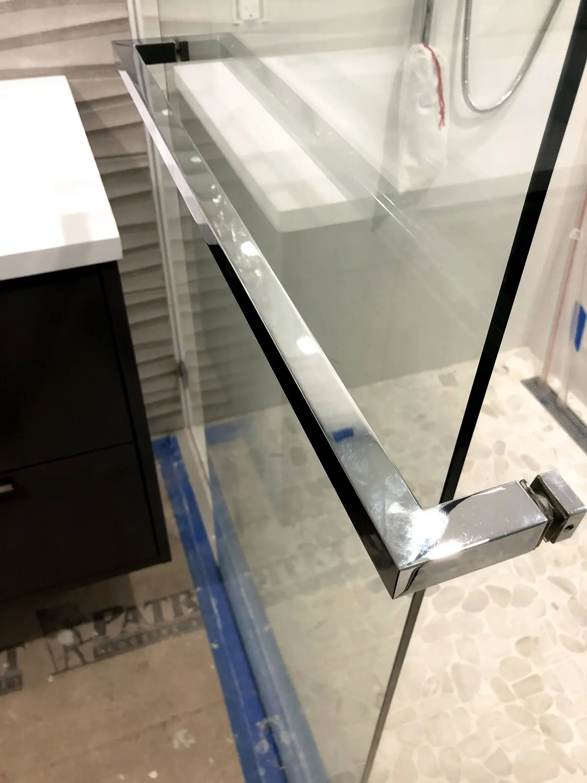 Clear glass balcony railing on a white modern home