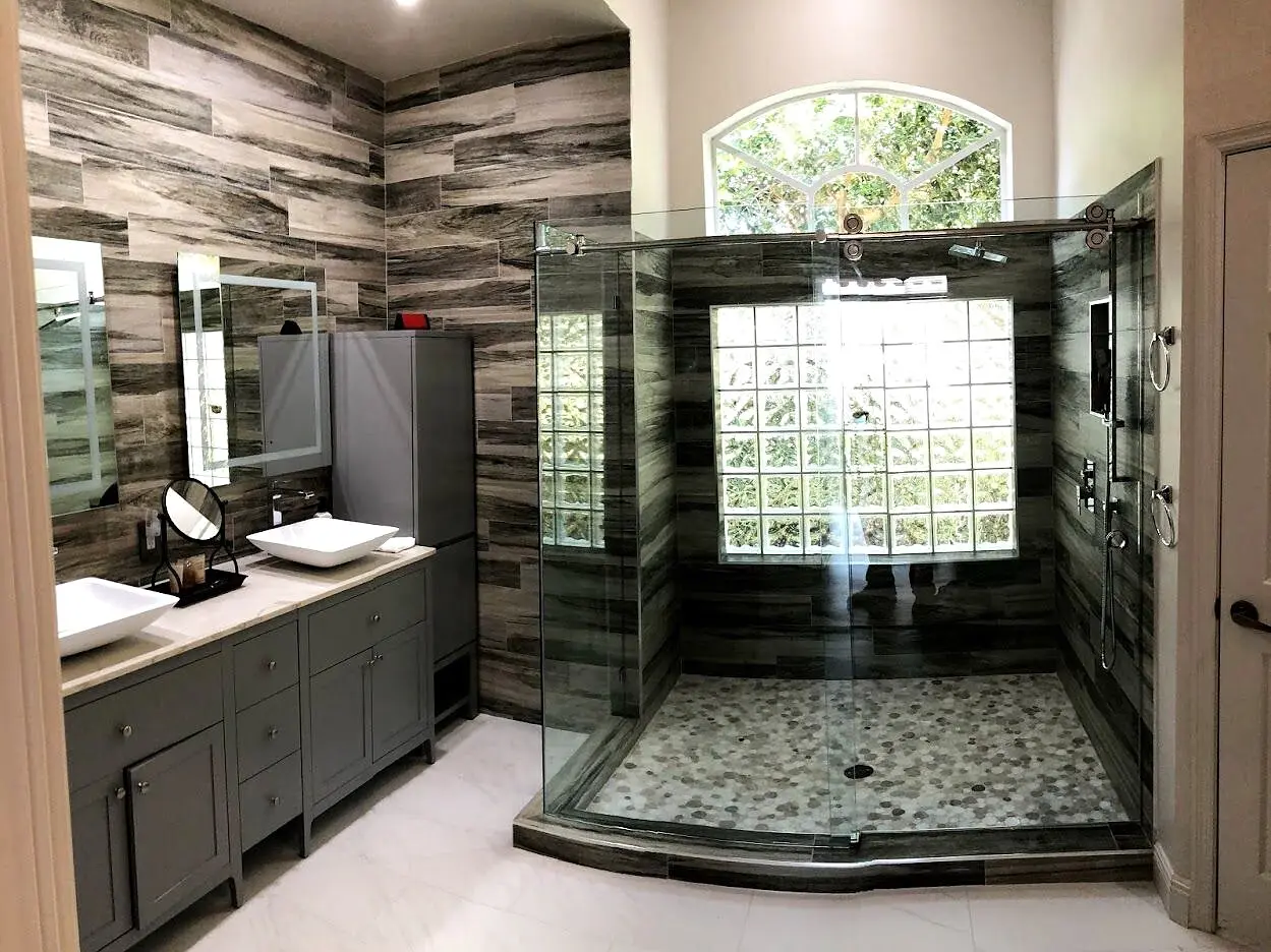 Large frameless glass shower enclosure in a finished bathroom