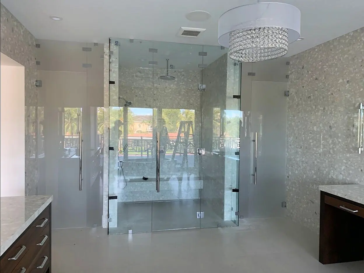 Bright custom glass shower enclosure with arched bathroom windows